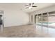 Spacious living room with backyard views, ceiling fan and neutral tile flooring at 23800 N 169Th Ave, Surprise, AZ 85387