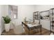 This modern home office features stylish decor, a sleek desk, and ample natural light, perfect for productivity at 23800 N 169Th Ave, Surprise, AZ 85387
