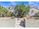 Landscaped backyard featuring lush green bushes, mature trees and privacy wall at 25038 W Rancho Vista Dr, Buckeye, AZ 85326