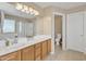 Bathroom with double sink vanity, shower, and toilet in a well-lit, neutral-toned space at 25038 W Rancho Vista Dr, Buckeye, AZ 85326