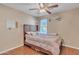 Bedroom featuring a bed with wood floors, a ceiling fan, and a window for natural light at 25038 W Rancho Vista Dr, Buckeye, AZ 85326