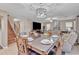 Open-concept dining area featuring seating for six, with staircase and access to a spacious living room at 25038 W Rancho Vista Dr, Buckeye, AZ 85326