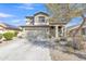Charming two-story home featuring a well-manicured yard, covered porch, and attached two-car garage at 25038 W Rancho Vista Dr, Buckeye, AZ 85326