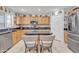 Well-lit kitchen with light wood cabinets, granite countertops, stainless steel appliances, and tile flooring at 25038 W Rancho Vista Dr, Buckeye, AZ 85326