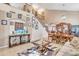 Open-concept living room with a staircase, an entertainment center, and neutral-toned furnishings at 25038 W Rancho Vista Dr, Buckeye, AZ 85326