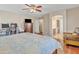 Large bedroom featuring hardwood floors, a ceiling fan, and an arched entrance at 25038 W Rancho Vista Dr, Buckeye, AZ 85326