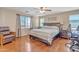 Bright bedroom with hardwood floors, a ceiling fan, and natural light from windows at 25038 W Rancho Vista Dr, Buckeye, AZ 85326