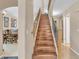 Traditional wood staircase featuring decorative wrought iron railings and natural light at 25038 W Rancho Vista Dr, Buckeye, AZ 85326