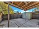 A spacious backyard featuring a covered patio, concrete paving, and a storage shed at 2604 W Wolf St, Phoenix, AZ 85017