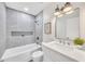 Well-lit bathroom with a tiled shower, modern fixtures, and a stylish vanity at 2604 W Wolf St, Phoenix, AZ 85017