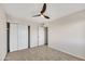 Carpeted bedroom featuring a ceiling fan and ample closet space at 2604 W Wolf St, Phoenix, AZ 85017
