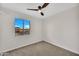 Comfortable bedroom featuring a large window, ceiling fan, and neutral decor at 2604 W Wolf St, Phoenix, AZ 85017