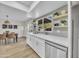 Well-lit kitchen with stainless steel dishwasher and adjacent dining area at 2604 W Wolf St, Phoenix, AZ 85017