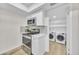 Efficient kitchen space with modern appliances and adjacent laundry area at 2604 W Wolf St, Phoenix, AZ 85017