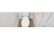 Clean and efficient toilet installed on wood grain flooring at 2604 W Wolf St, Phoenix, AZ 85017