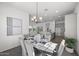 Elegant dining room next to kitchen and living room, modern chandelier, and contemporary decor at 26417 N 22Nd Dr, Phoenix, AZ 85085