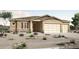 Charming single-story home with a stucco exterior, stone accents, desert landscaping, and a three-car garage at 28251 N 134Th Dr, Peoria, AZ 85383