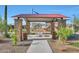 Park pavilion with stone columns, a metal roof, seating, and trash receptacles for community gatherings at 28251 N 134Th Dr, Peoria, AZ 85383