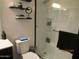 Bright bathroom featuring a modern shower with glass door and contemporary fixtures at 3004 W Running Deer Trl, Phoenix, AZ 85083