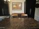 Dining area with dark cabinets, granite countertop, a large artwork and dining furniture at 3004 W Running Deer Trl, Phoenix, AZ 85083