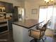 Kitchen with stainless appliances and a counter bar with two chairs and pendant lighting at 3004 W Running Deer Trl, Phoenix, AZ 85083