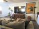 Inviting living room with a large sofa, throw pillows, entertainment center, and stylish decor at 3004 W Running Deer Trl, Phoenix, AZ 85083