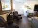 Open living room space with an armchair, large mirror, and view to front door at 3004 W Running Deer Trl, Phoenix, AZ 85083