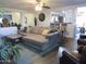 Spacious living room with a large sectional sofa and open access to the kitchen at 3004 W Running Deer Trl, Phoenix, AZ 85083