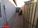 Narrow side yard with gravel landscaping, a gate, and access to the backyard at 3004 W Running Deer Trl, Phoenix, AZ 85083