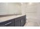 Bathroom with granite countertops, dark cabinets, and a shower-tub combination at 3252 W Peak View Rd, Phoenix, AZ 85083