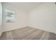 Cozy bedroom with neutral carpet, base molding, and natural light from the window at 3252 W Peak View Rd, Phoenix, AZ 85083