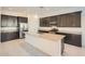 Modern kitchen with stainless steel appliances, a central island, and dark wood cabinets at 3252 W Peak View Rd, Phoenix, AZ 85083