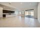 Spacious living room and kitchen featuring an open floor plan and sliding glass doors at 3252 W Peak View Rd, Phoenix, AZ 85083