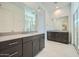 Main bathroom featuring dual vanities, sleek countertops, and glass-enclosed shower at 3252 W Peak View Rd, Phoenix, AZ 85083