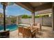 A cozy back patio provides ample shade and comfortable seating, overlooking the beautiful backyard pool at 3527 E Arabian Dr, Gilbert, AZ 85296