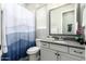 Bathroom with a large mirror, a toilet, and a shower with a blue and white curtain at 3527 E Arabian Dr, Gilbert, AZ 85296