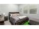 This bedroom features a modern bed with a wood headboard and many windows for ample sunlight at 3527 E Arabian Dr, Gilbert, AZ 85296