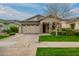 Charming single-story home with a well-maintained lawn, paver driveway and stone accents on the front facade at 3527 E Arabian Dr, Gilbert, AZ 85296