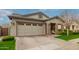Close-up of house showing large two-car garage, gray stucco exterior, and stone accents at 3527 E Arabian Dr, Gilbert, AZ 85296