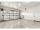 A bright, two-car garage is wired for EV charging with a clean door and white walls at 3527 E Arabian Dr, Gilbert, AZ 85296