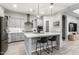 Well-lit kitchen with a central island, modern pendant lights, and gray cabinetry at 3527 E Arabian Dr, Gilbert, AZ 85296