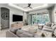 Living room featuring a large TV, modern furnishings and backyard pool view through sliding doors at 3527 E Arabian Dr, Gilbert, AZ 85296