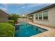 A beautiful pool area showcases clean blue water, a tiled edge, and a lush landscaped patio at 3527 E Arabian Dr, Gilbert, AZ 85296