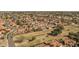 Charming bird's eye view of a neighborhood, displaying a lush greenbelt and meticulously maintained lawns at 3620 N Aspen Dr, Avondale, AZ 85392