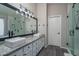 Bathroom featuring double sinks, a modern faucet, vanity lighting, and glass shower at 3620 N Aspen Dr, Avondale, AZ 85392