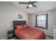Comfortable bedroom with a ceiling fan, window bench, and stylish decor at 3620 N Aspen Dr, Avondale, AZ 85392