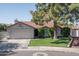 Beautiful single-Gathering home featuring manicured lawn, a mature shade tree, and an attached two-car garage at 3620 N Aspen Dr, Avondale, AZ 85392