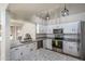 Modern kitchen with stainless steel appliances, granite countertops, and white cabinetry at 3620 N Aspen Dr, Avondale, AZ 85392