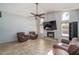 Spacious living room featuring a fireplace with tile accents and ceiling fan at 3620 N Aspen Dr, Avondale, AZ 85392