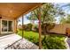 Cozy covered patio overlooking a lush backyard with artificial grass and mature landscaping at 405 E Wescott Dr, Phoenix, AZ 85024